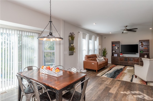 dining room featuring hardwood / wood-style flooring and ceiling fan with notable chandelier