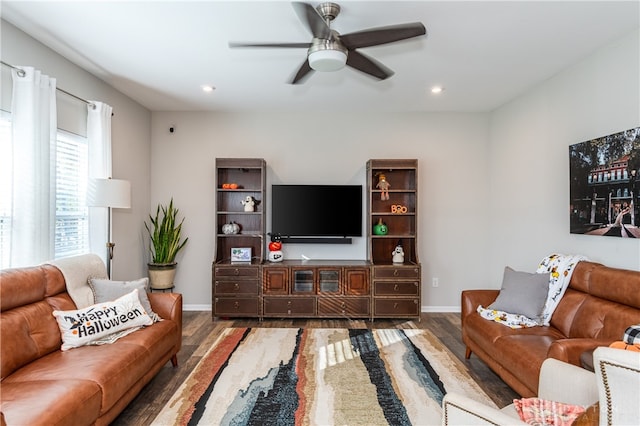 living room with ceiling fan and dark hardwood / wood-style flooring