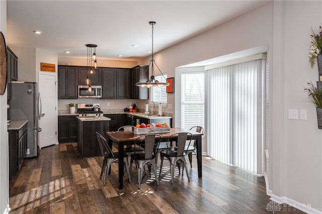 dining space with sink and dark hardwood / wood-style floors