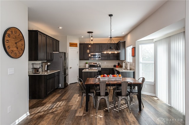 dining room featuring an inviting chandelier and dark wood-type flooring