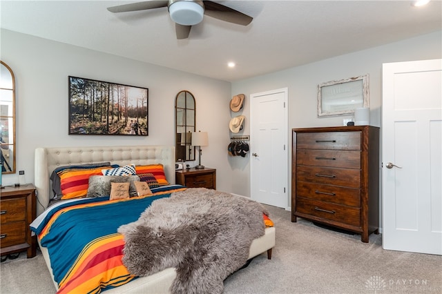 bedroom featuring light carpet and ceiling fan