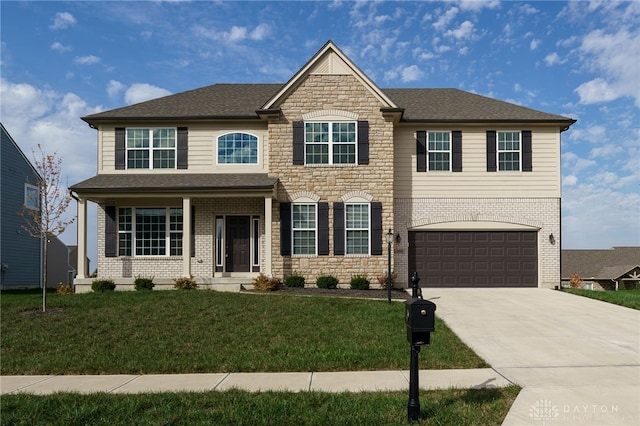 view of front of home featuring a front yard and a garage