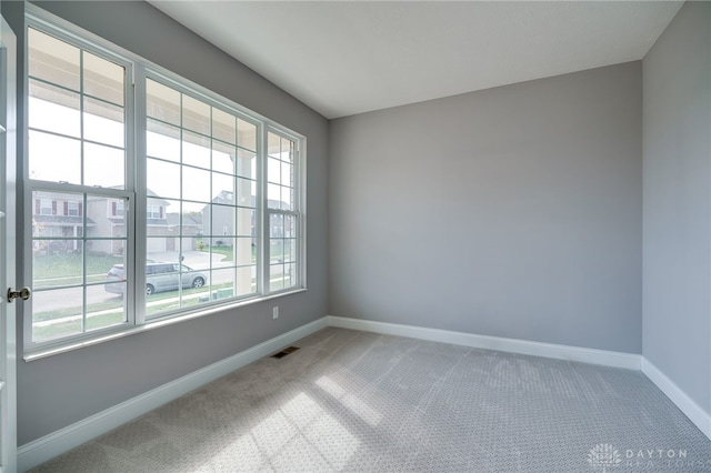 unfurnished room featuring carpet