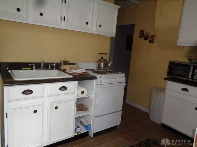 laundry room with dark hardwood / wood-style flooring and sink