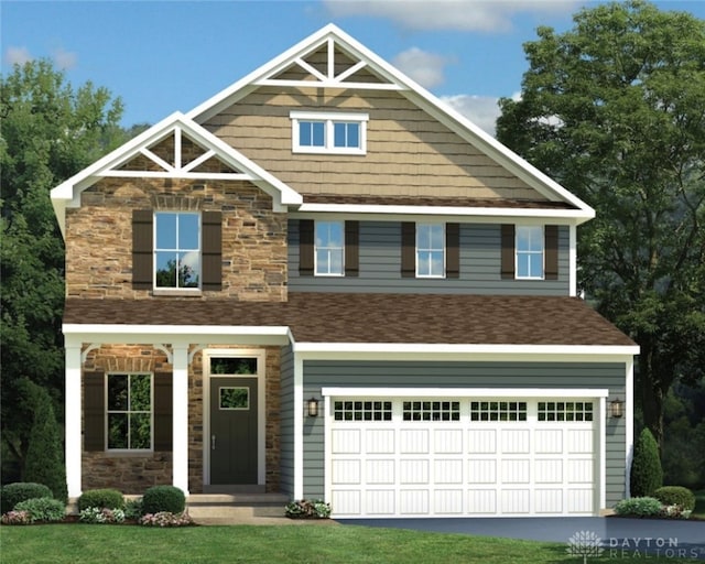 view of front of property with a front yard and a garage