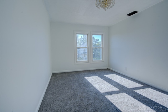 empty room with dark carpet