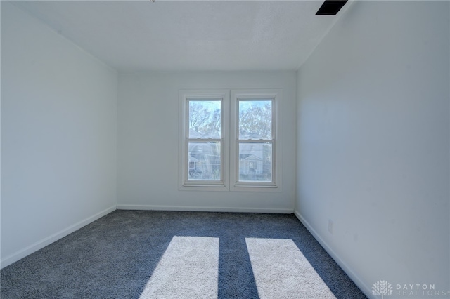 empty room featuring dark carpet