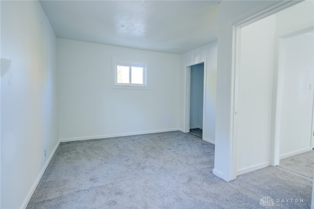 spare room with light colored carpet