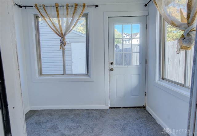 doorway with light colored carpet