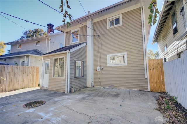 back of property with a patio