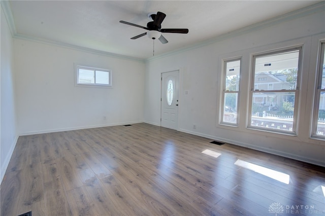 foyer entrance featuring ornamental molding, hardwood / wood-style floors, ceiling fan, and a wealth of natural light