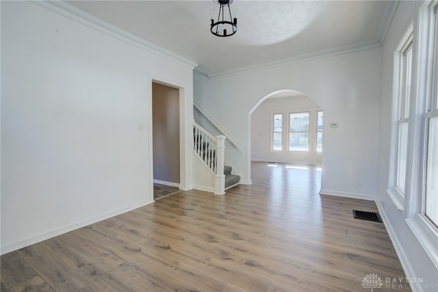 interior space with crown molding and hardwood / wood-style flooring