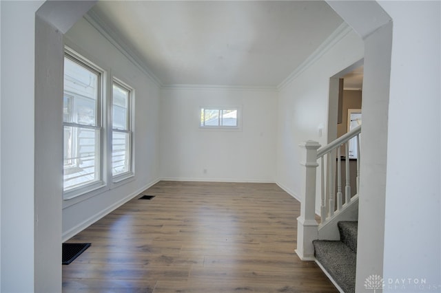 unfurnished room with ornamental molding and dark hardwood / wood-style flooring