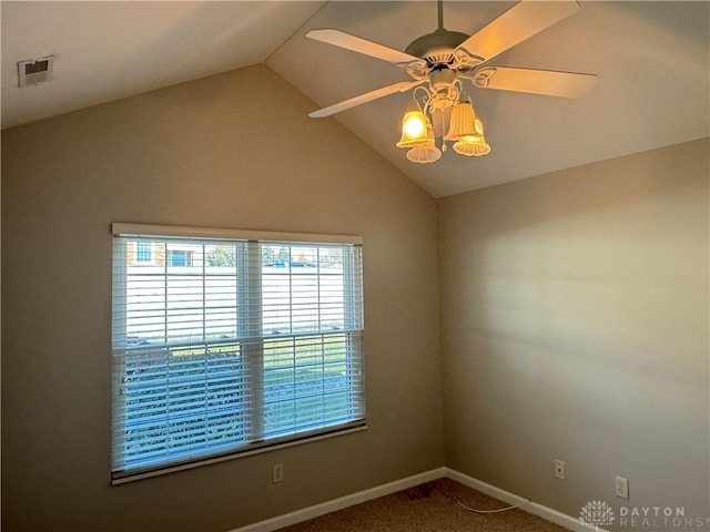 spare room with vaulted ceiling, ceiling fan, and carpet floors