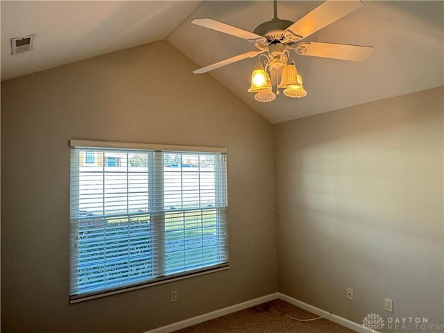 spare room with visible vents, a ceiling fan, carpet, baseboards, and vaulted ceiling