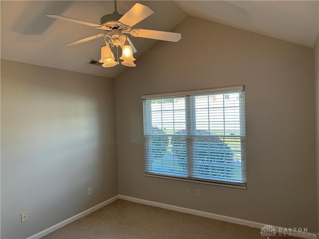 unfurnished room featuring vaulted ceiling, baseboards, visible vents, and ceiling fan