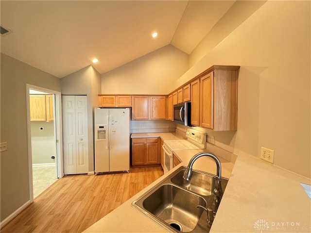 kitchen featuring light hardwood / wood-style floors, sink, white fridge with ice dispenser, vaulted ceiling, and electric range