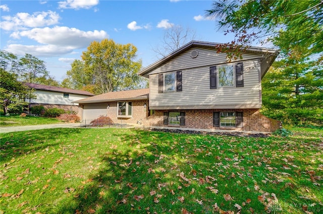 tri-level home with a front lawn and a garage