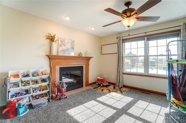 recreation room with carpet flooring and ceiling fan