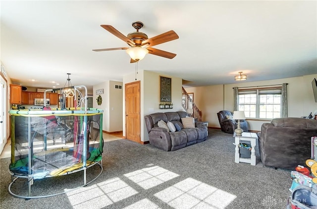 living room featuring ceiling fan and light carpet