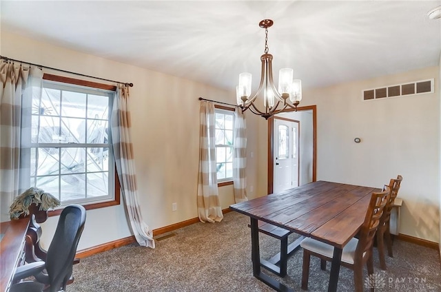 dining space with carpet floors and a notable chandelier