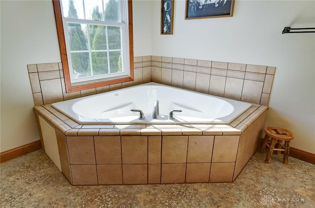 bathroom featuring tiled tub