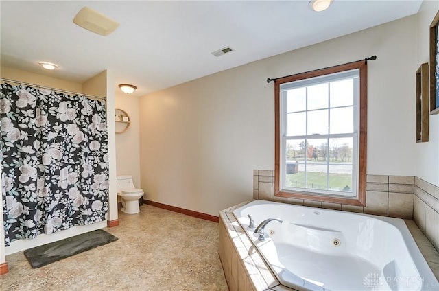 bathroom with a relaxing tiled tub and toilet