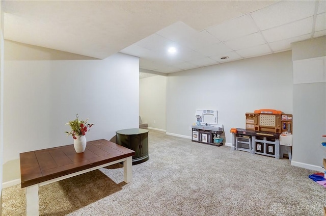 interior space with a drop ceiling and carpet