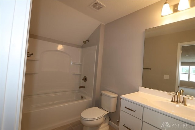 full bathroom with vanity,  shower combination, lofted ceiling, tile patterned floors, and toilet