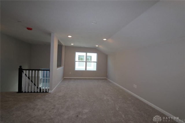 bonus room with carpet flooring and vaulted ceiling