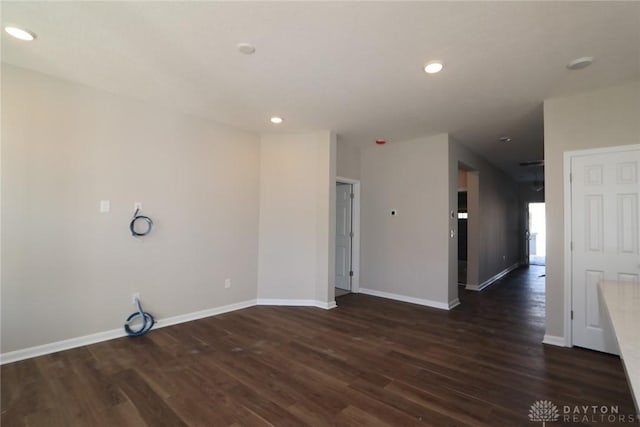 unfurnished room with dark wood-type flooring