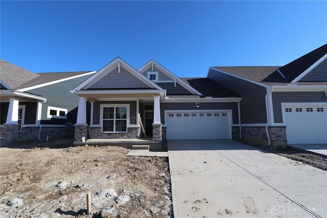 craftsman-style house featuring a porch and a garage