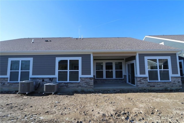 back of property featuring central air condition unit and a patio