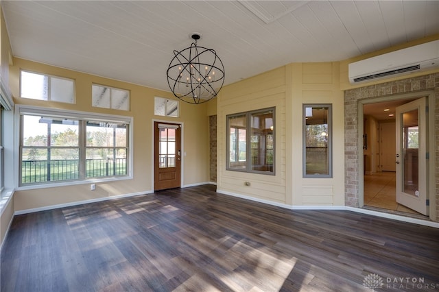 interior space with wood ceiling, a chandelier, a wall unit AC, and plenty of natural light