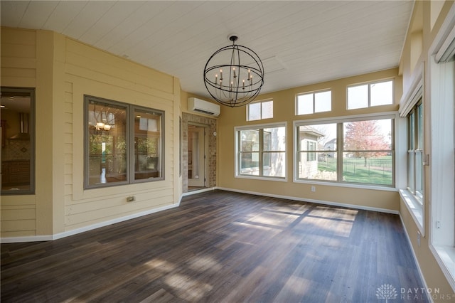 unfurnished sunroom featuring a wall unit AC and a chandelier