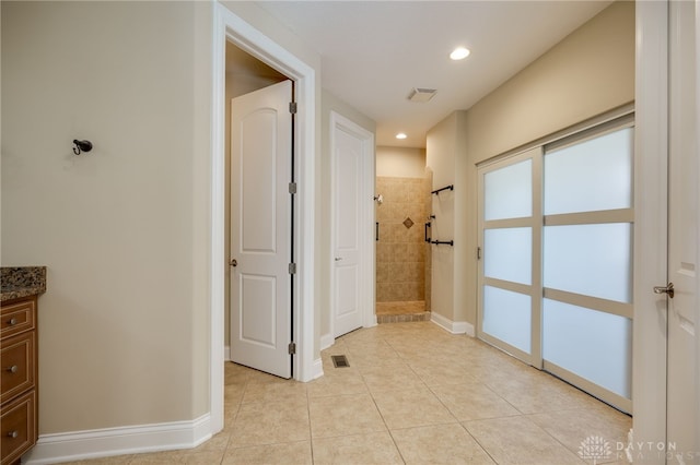 hall with light tile patterned floors