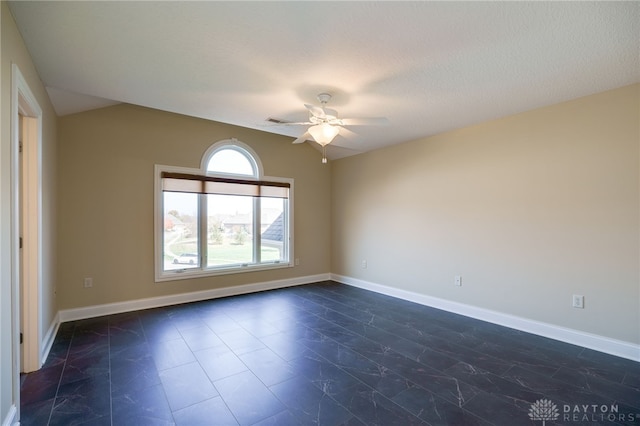 unfurnished room featuring ceiling fan and a textured ceiling