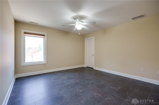 empty room with a textured ceiling and ceiling fan