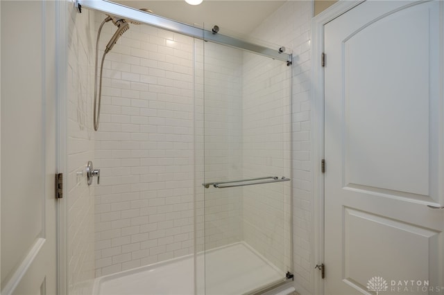 bathroom featuring a shower with door