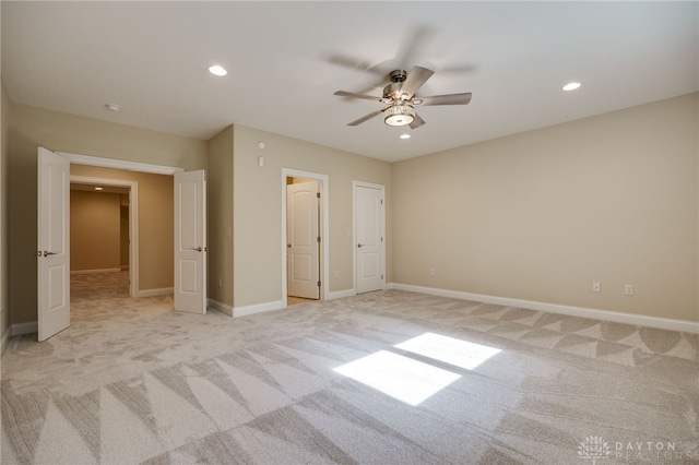 unfurnished bedroom featuring light carpet and ceiling fan