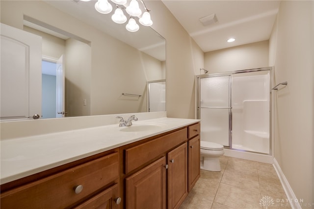 bathroom featuring toilet, vanity, tile patterned floors, and a shower with door