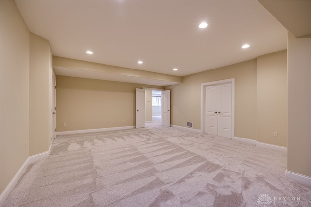 spare room featuring light colored carpet