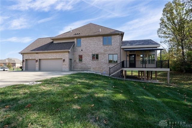 back of house featuring a yard, covered porch, and a garage