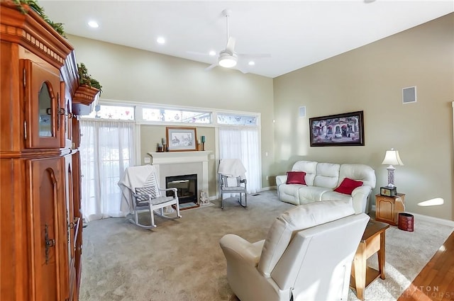 carpeted living room with ceiling fan