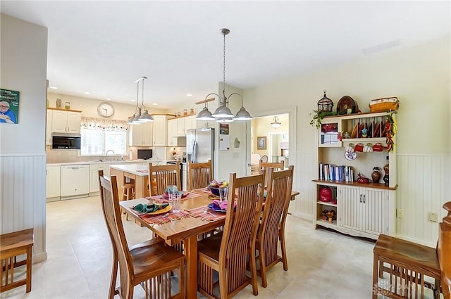 dining room featuring a notable chandelier and sink