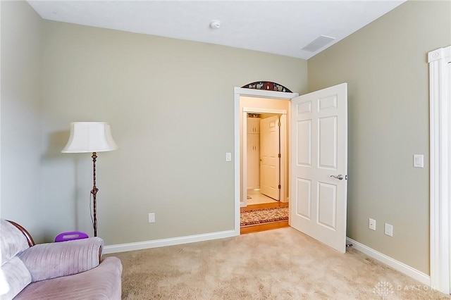 sitting room featuring light colored carpet