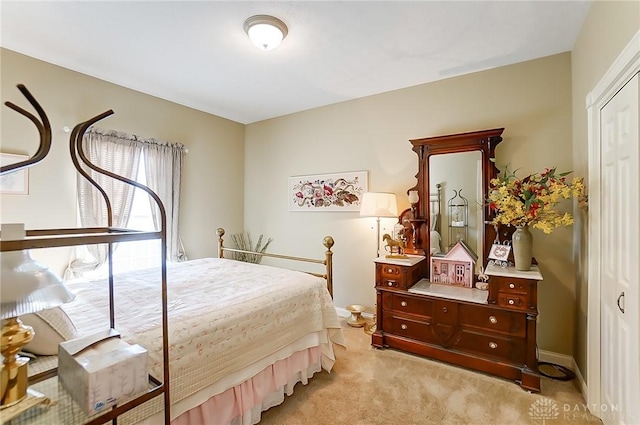 bedroom with light carpet and a closet