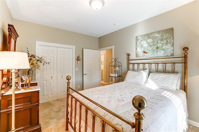 bedroom featuring a closet and light colored carpet