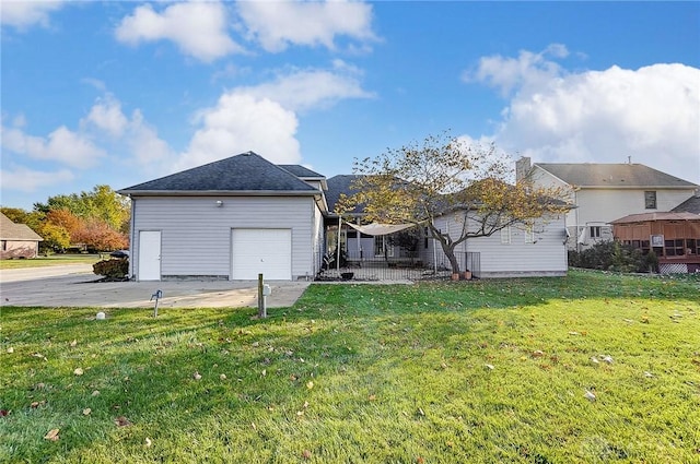 rear view of house with a garage and a yard