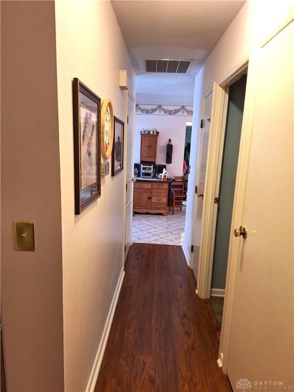 hallway with dark hardwood / wood-style flooring